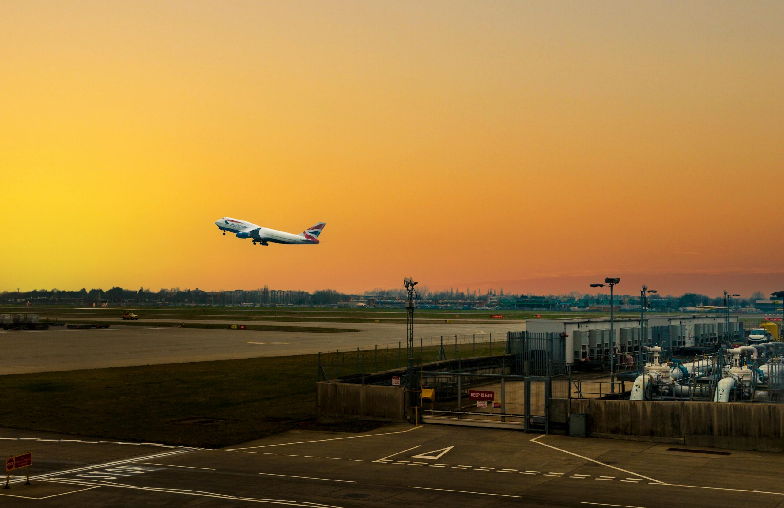 A commercial airliner accelerates down the runway, lifting off the ground and soaring into the sky. 
