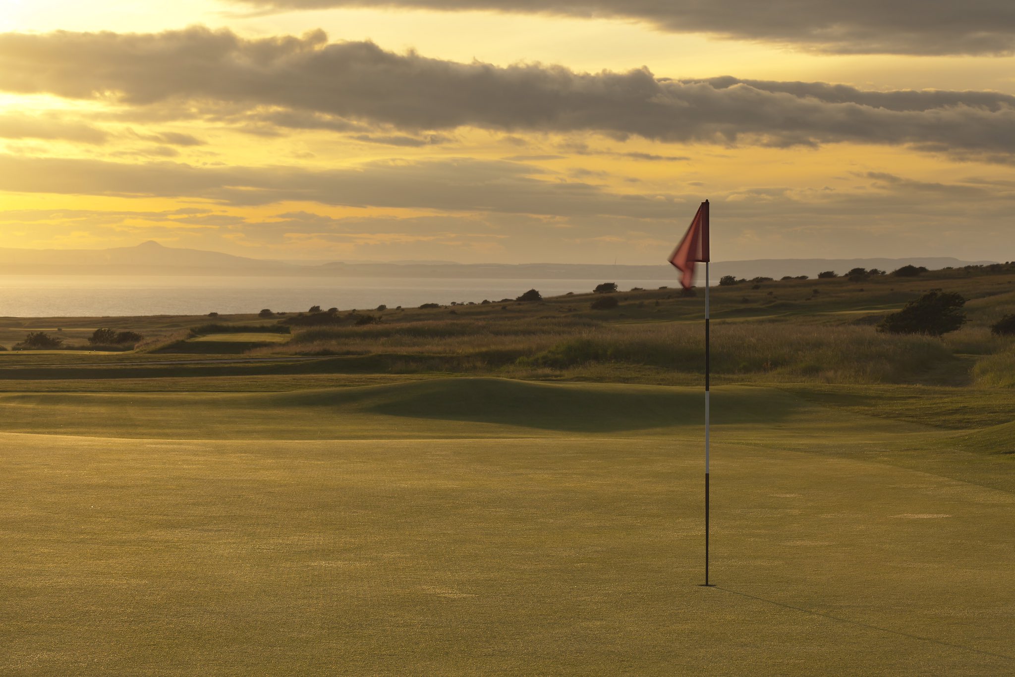 An image of a flag on the course at Gullane Golf Club, Scotland.